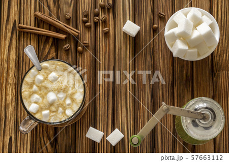 Morning natural coffee with milk and marshmallows and manual coffee grinder Morning natural coffee with milk and marshmallows and manual coffee grinder 57663112