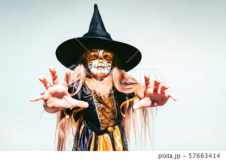 Little girl like a witch on white background Little girl like a witch on white background 57663414