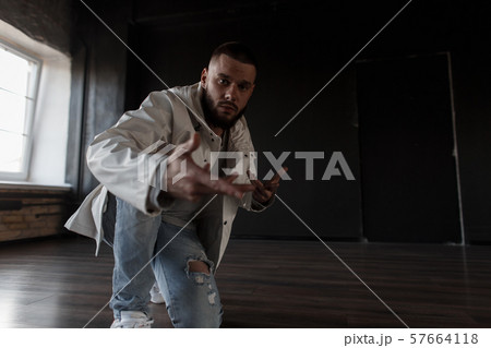 Handsome young man dancer in fashionable jacket 57664118