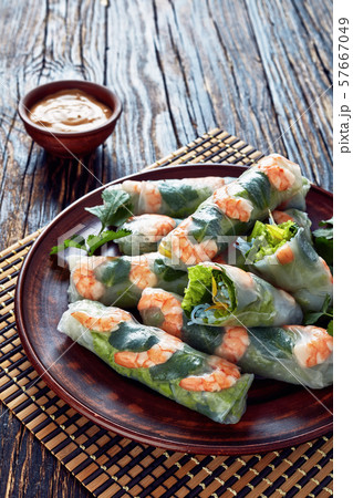fresh raw Asian spring rolls vertical view fresh raw Asian spring rolls vertical view 57667049