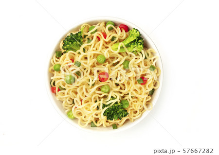 A bowl of soba noodles with vegetables, shot from the top on a white background 57667282