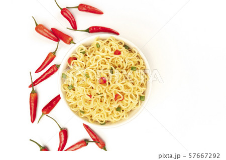 Soba noodles, shot from above on a white background with red peppers and copy space Soba noodles, shot from above on a white background with red peppers and copy space 57667292