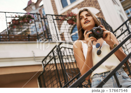 Catching the moment. Beautiful girl walking around the summer city 57667546