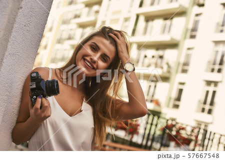 Young and relaxed. Beautiful girl standing on summer terrace 57667548