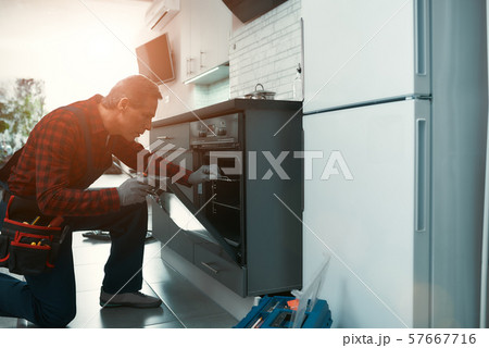 Quality work. Man solves household problems. Side view Quality work. Man solves household problems. Side view 57667716