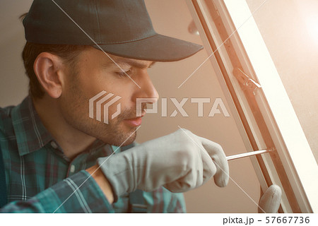 Doing it right. Man is installing a window 57667736