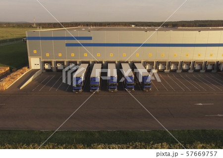 large warehouse complex with parked trucks awaiting loading. Logistics center, warehouse terminal 57669757