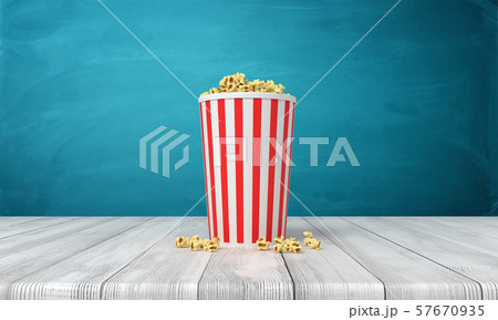 3d rendering of popcorn bucket on wooden surface near blue wall with copy space. 57670935