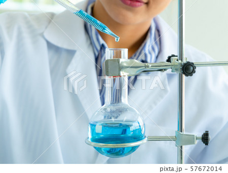 Young female doing experiments and researchers Young female doing experiments and researchers 57672014