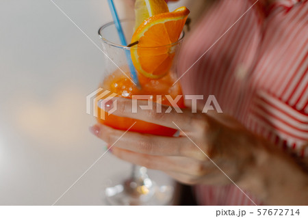 Beautiful girl with a bright fresh cocktail in a 57672714