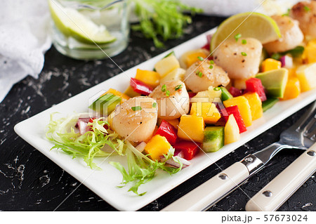 Seared scallops with mango and pineapple salsa 57673024