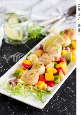 Seared scallops with mango and pineapple salsa 57673044