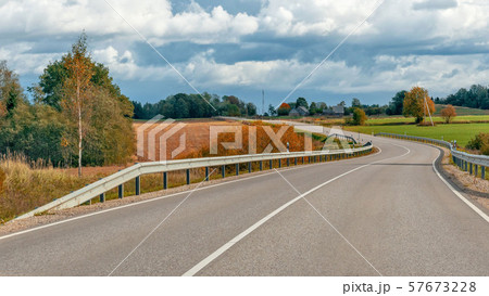 Autumn landscape with asphalt road and forest. Autumn landscape with asphalt road and forest. 57673228