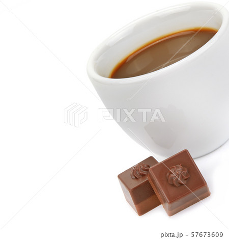 Cup of coffee and chocolate candies on white Cup of coffee and chocolate candies on white 57673609