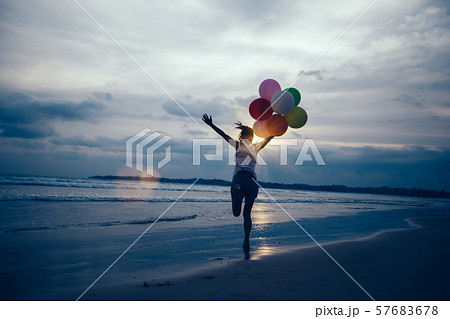 young asian woman running and jumping on seaside young asian woman running and jumping on seaside 57683678