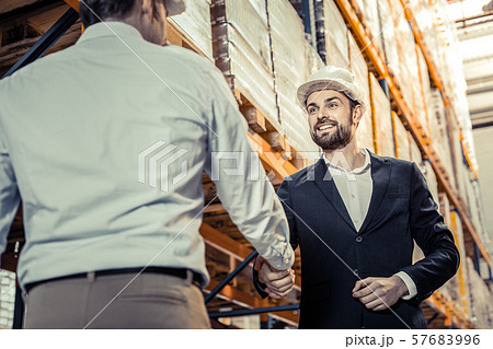 Cheerful bearded male person welcoming his partner Cheerful bearded male person welcoming his partner 57683996