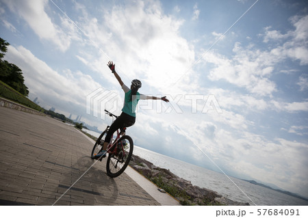 Hands free cycling woman riding Mountain Bike on Hands free cycling woman riding Mountain Bike on 57684091