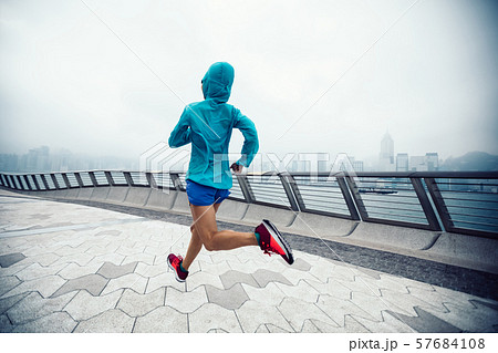 Healthy lifestyle woman runner running on foggy 57684108