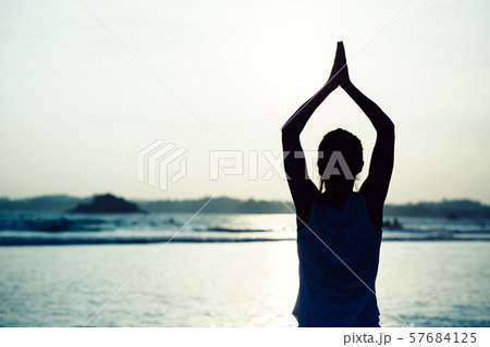 Woman pracice yoga on sunset beach Rear View 57684125