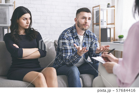 Young man talking to psychotherapist at marital consultation 57684416
