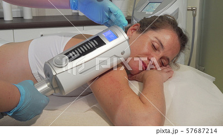 Beautician doing edospheres therapy massage on arms of a female client 57687214