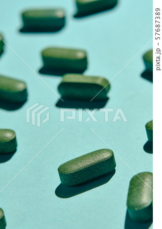 capsules, pills and tablets on blue background 57687389