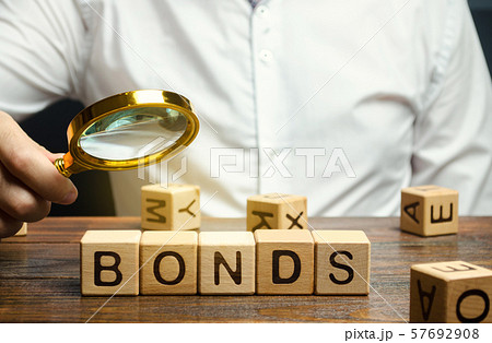 Wooden blocks with the word Bonds and businessman. 57692908