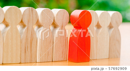 Wooden figures of people. The red man comes out Wooden figures of people. The red man comes out 57692909