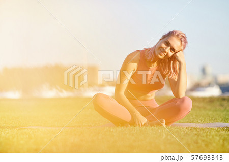 Happy woman resting on the grass Happy woman resting on the grass 57693343