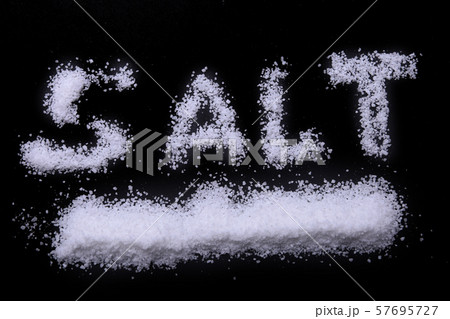 White sea salt isolated on a black background. Selective focus. 57695727