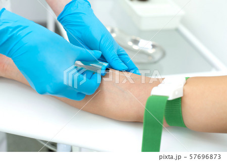 a nurse in the clinic inserts a catheter into a a nurse in the clinic inserts a catheter into a 57696873