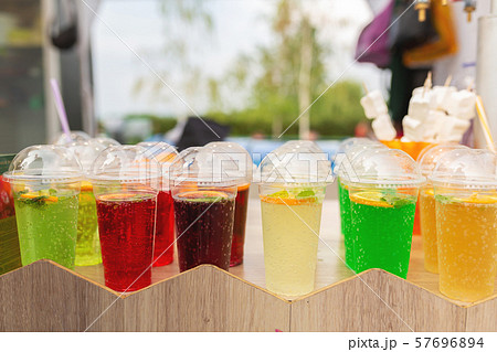 A counter with multi-colored fruit cocktails in 57696894