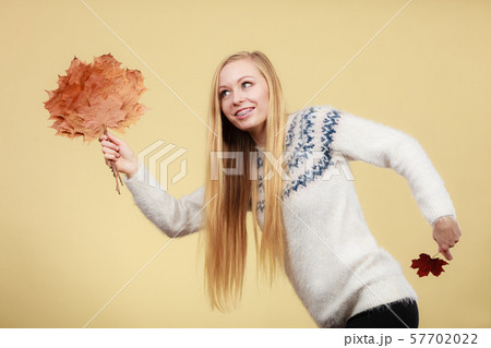 Woman holding bouquet made of autumn leaves 57702022