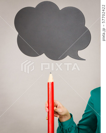 Woman holding pencil, black thinking bubble 57702422