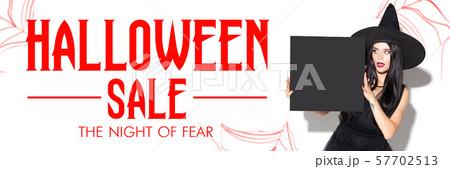 Young woman in hat as a witch on scary white background 57702513