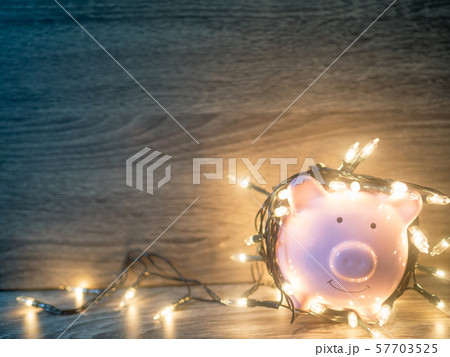 Pink piggy bank with Party lights, Enjoy savings for the holidays concept 57703525