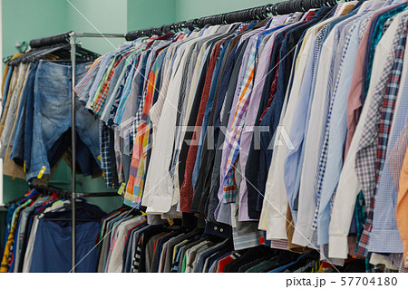 Colorful clothes on hangers in a store. 57704180