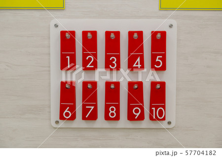 Row of metal lockers with locks, keys and numbered 57704182