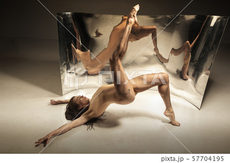 Young and stylish modern ballet dancer on brown background 57704195