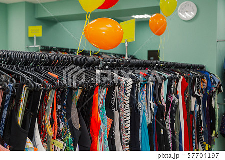 Colorful clothes on hangers in a store. 57704197