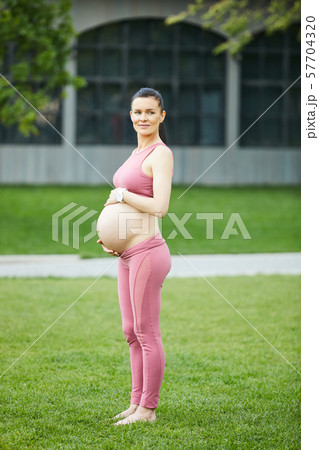 Beautiful pregnant woman in the park Beautiful pregnant woman in the park 57704320