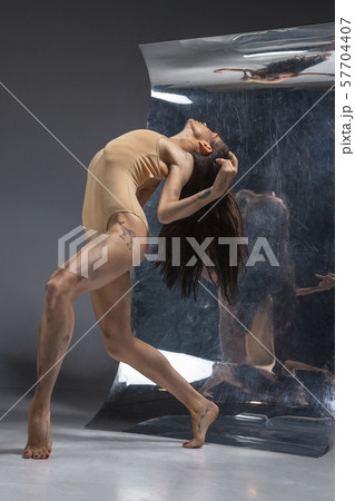 Young and stylish modern ballet dancer on grey background 57704407
