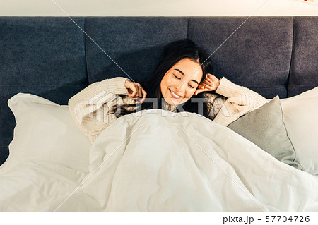 Smiling young woman being ready to sleep Smiling young woman being ready to sleep 57704726