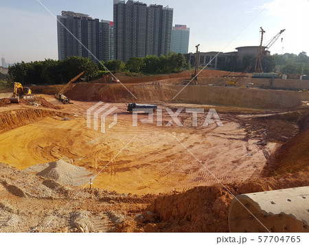 Heavy machinery doing the earthwork and site clearing at the construction site. Heavy machinery doing the earthwork and site clearing at the construction site. 57704765