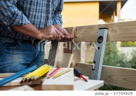 Craftsman at work on wooden boards. 57704929