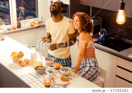 Joyful international couple having fun during breakfast 57705161