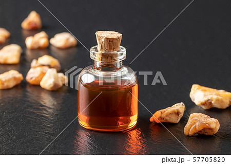 A bottle of styrax benzoin essential oil with benzoin resin A bottle of styrax benzoin essential oil with benzoin resin 57705820
