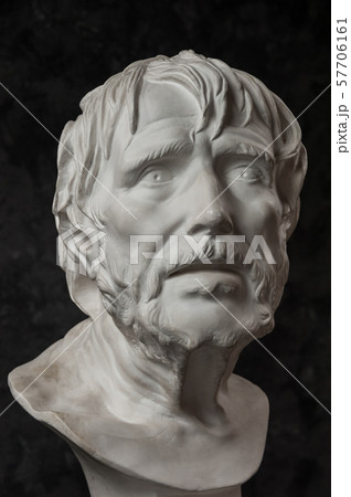 Gypsum copy of ancient statue Seneca head on dark textured background. Plaster sculpture man face. 57706161