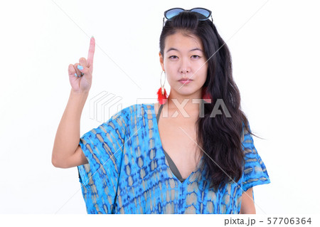 Portrait of beautiful Asian tourist woman pointing up ready for vacation 57706364