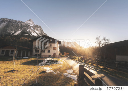 Winter scenery with the snowy Alps and alpine farm 57707284